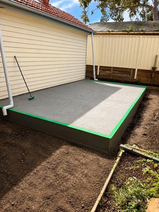 Finished slab with a continuous perimeter barrier
